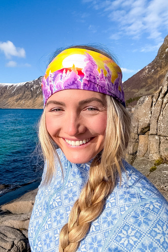 Blond woman wearing The Snowy Path headband in front of a lake